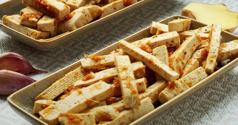 Raw tofu in ginger marinate. Table spin, zoom-in. Stock Footage 277504481