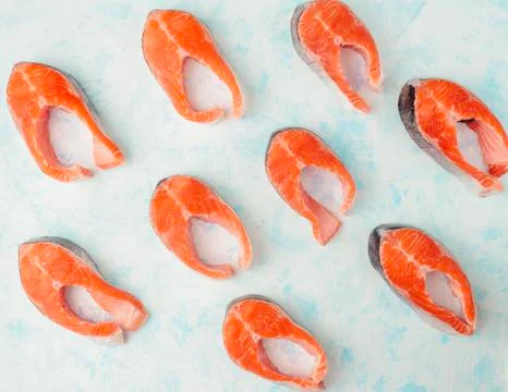 Raw trout steak pattern on aqua menthe background top view Stock Photos