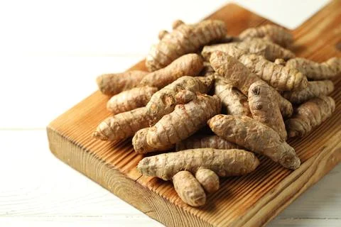 Raw tumeric rhizomes on white table, closeup Stock Photos