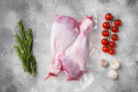 Raw turkey thigh vacuum pack, top view flat lay, on gray stone table backgrou Stock Photos