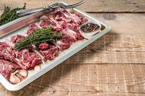 Raw uncooked lamb mutton meat chops steaks with thyme and garlic. Wooden Stock Photos