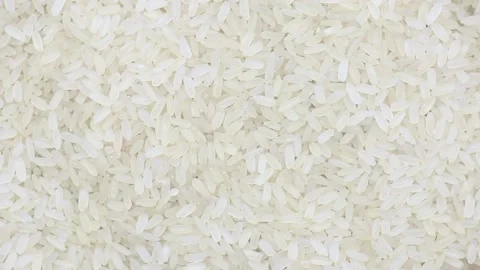 Raw uncooked rice long grain spinning close-up Stock Footage 136561353