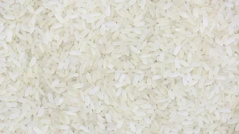 Raw uncooked rice long grain spinning close-up Stock Footage 137971087