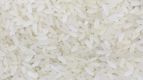 Raw uncooked rice long grain spinning close-up Stock-Footage 139922848