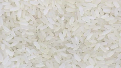 Raw uncooked rice long grain spinning close-up Stock Footage 140268866
