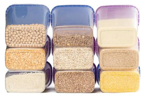 Raw various cereals in plastic containers Stock Photos