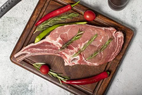 Raw veal chops. Fresh veal rib boned raw chops on wood serving board Stock Photos
