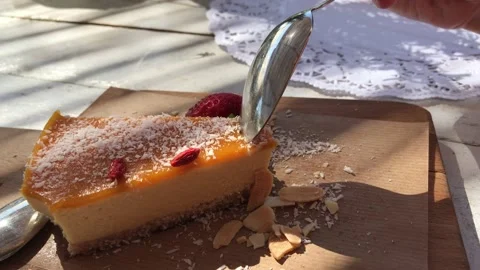 Raw vegan cheesecake with mango topping and goji. Stock Footage 132054673