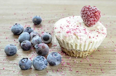 Raw vegan ice cream muffin with blueberries and raspberry Stock Photos