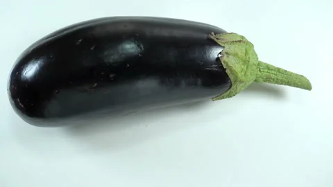 Raw vegetable eggplant rotates in 4K Stock Footage 139799364