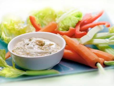 Raw vegetables served on a plate with a dip sauce.. Stock Photos