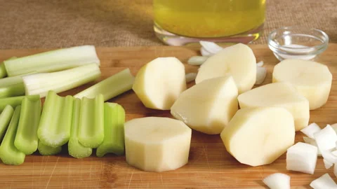 Raw vegetables, such as celery sticks, potatoes, onion Stock Footage 223994458