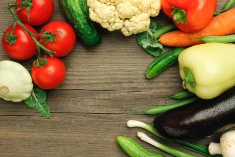 Raw vegetables on a wooden surface Stock Photos