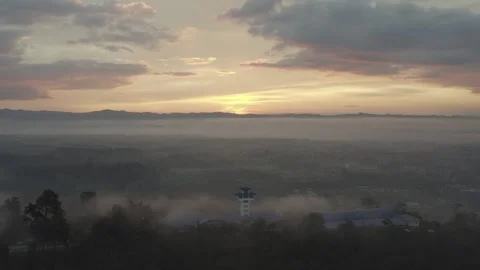 RAW video of Backward drone shot fog sunrise of cross building Stock Footage 247404848