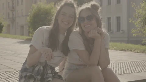 Raw video. Two young beautiful smiling hipster girls Stock-Footage 142375435