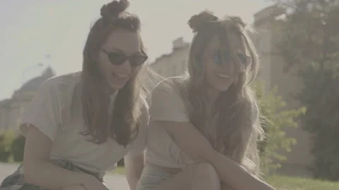 Raw video. Two young beautiful smiling hipster girls Stock Footage 142376452