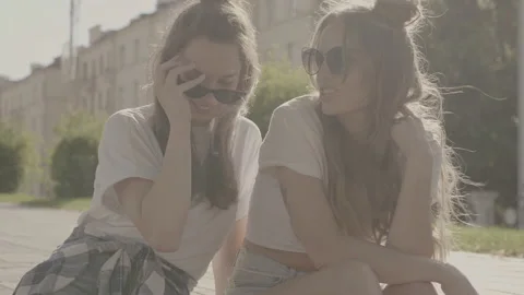 Raw video. Two young beautiful smiling hipster girls Stock Footage 142376620