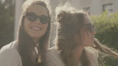 Raw video. Two young beautiful smiling hipster girls Stock Footage 142377453