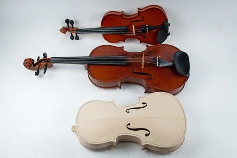 Raw violin put in front of two completed violin Stock-Fotos