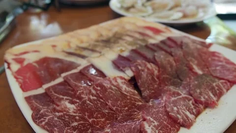 Raw Wagyu A5 beef sliced with marbled texture. Japanese food. Tilt down. Stock Footage 157527035