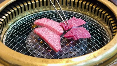 Raw Wagyu Beef Slices Grilling on a Japanese Charcoal Yakiniku BBQ 库存影片 331563452