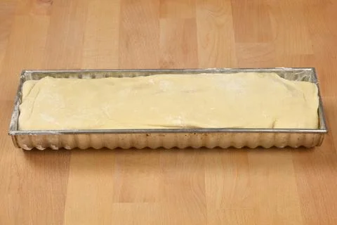 Raw walnut roll dough in a baking mold Stock Photos