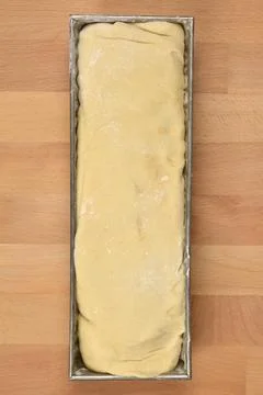 Raw walnut roll dough in a baking tin Stock Photos