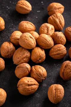 Raw walnut in shell on old rustic background Stock Photos