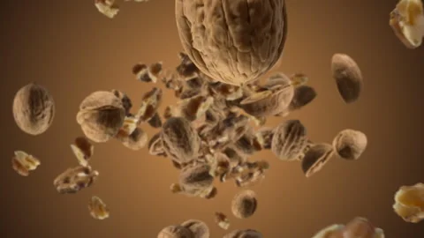 Raw walnuts chunks exploding and flying in super slow motion. Pieces of walnuts Stock Footage 317193472