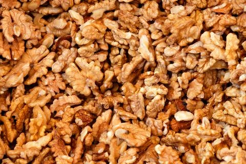 Raw walnuts outside of shell pile background pattern Stock Photos