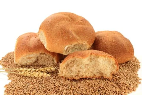 Raw wheat kernels, wheatears and whole wheat buns Stock Photos