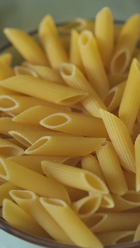 Raw Wheat Penne Pasta in Kitchen Setting Boom Shot Stock Footage 313369925