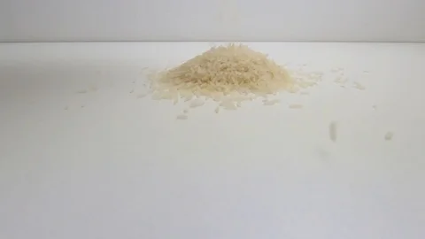 The raw white basmati rice grains on the white table. Close up, detail, POV. Stock Footage 128845800