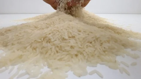 The raw white basmati rice grains on the white table. Close up, detail, POV. Stock Footage 128845870