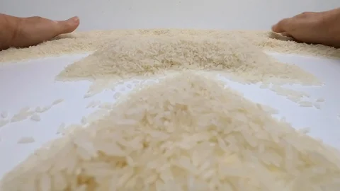 The raw white basmati rice grains on the white table. Close up, detail, POV. Stock Footage 128845983