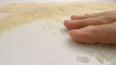 The raw white basmati rice grains are chosen and cleaning POV. Stock Footage 128846072