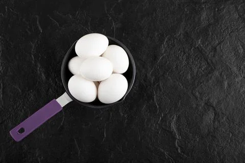 Raw white eggs on small pan Stock Photos