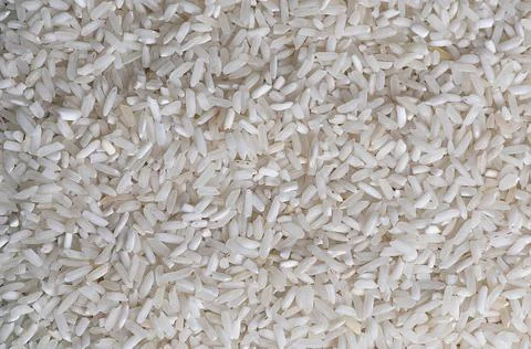 Raw white long rice macro background Stock Photos