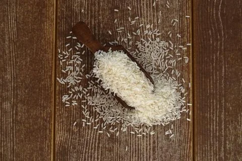 Raw white rice on dark rustic wooden background Stock Photos