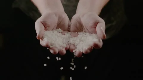 Raw White Rice Falling From Hands on a dark background. Stock Footage 231052054