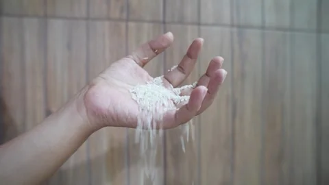 Raw white rice grains accidentally dropped from someone's hand. Stock Footage 340417734