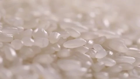 Raw white rice grains rotating in slow movement. Stock Footage 336332711