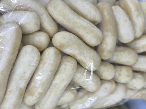 Raw white sausages in plastic packaging. Stock Photos