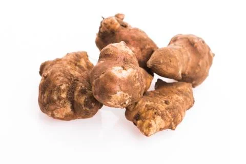 Raw Whole ans sliced Jerusalem artichokes on a white background Stock Photos