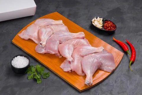 Raw whole chicken leg grey board Stock Photos