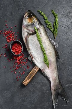 Raw whole fish silver carp. Black background. Top view Stock Photos