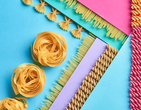 Raw whole pasta. Assorted Multi Colored Raw Pasta Pattern. Photo for the site Stock-Fotos