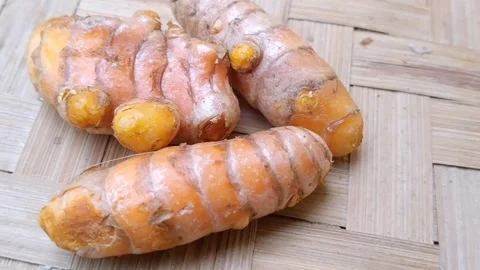 Raw Whole Turmeric Ingredients on Rustic Bamboo Mat Stock Footage 340538308