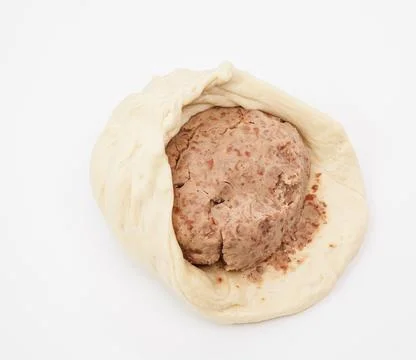 Raw Yeast Dough with Bean Paste Filling on a White Background Photos