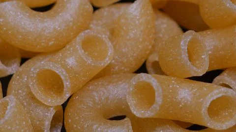 Raw yellow macaroni. Macro. Stock Photos